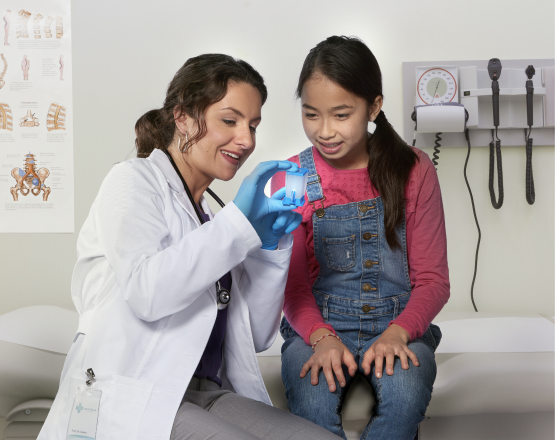 Physician shows pcr test cartridge to patient